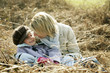 Mother and daughter in a stack of dried leaves