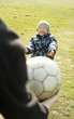 Father and son playing football