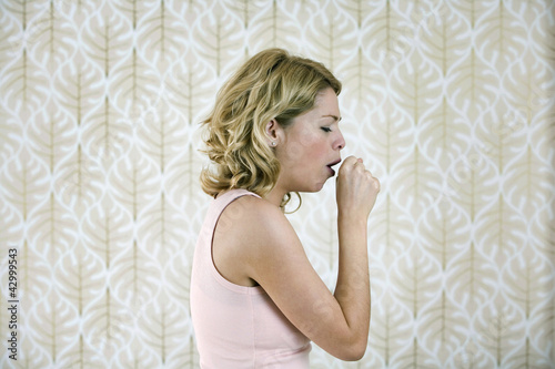 Photo: A woman coughing A woman coughing
