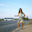 Woman showing a hitch hiking gesture