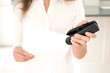 Businesswoman stapling papers