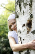 Woman hugging a tree in the park