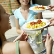 Women being served spaghetti