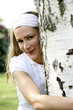 Woman hugging a tree in the park