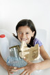 Girl gathering recyclable items on the table