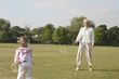 Senior woman and girl playing badminton