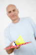 Senior man holding badminton racquet with shuttlecock on it