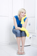 Woman with rubber gloves sitting on the toilet bowl