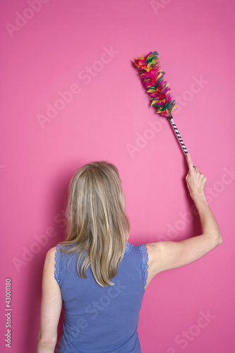 Photo: Woman dusting the wall Woman dusting the wall