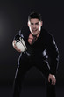 Businessman playing rugby