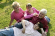 An old couple lying on the field with their grandchildren for a group photo