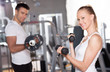 Couple working out with dumbbells