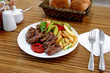 Foto: Meatball plate with hot sauce and French fries Meatball plate with hot sauce and French fries