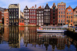 Traditional houses of Amsterdam with canal reflections