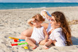 Mother with little daughter on the beach