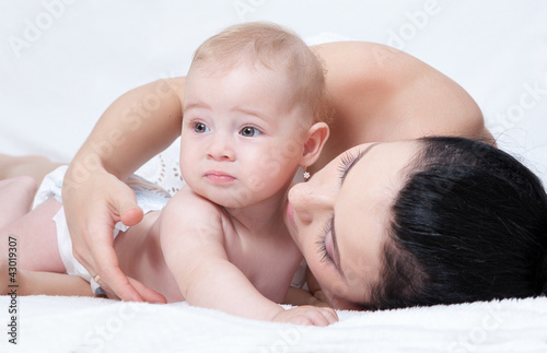 Photo: happy mother with baby over white happy mother with baby over white