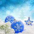 Christmas branch of tree blue baubles and snow background