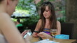 Vídeo: Female friends sending text message in outdoor bar Female friends sending text message in outdoor bar