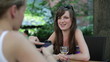Vídeo: Female friends with smartphone in outdoor bar Female friends with smartphone in outdoor bar