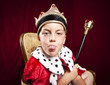 little boy dressed ad a king on red velvet background