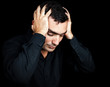 Photo: Hispanic man suffering a strong headache or depression Hispanic man suffering a strong headache or depression