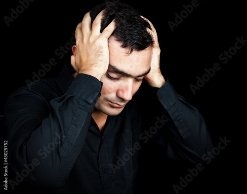 Photo: Hispanic man suffering a strong headache or depression Hispanic man suffering a strong headache or depression