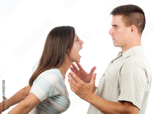 Photo: Young couple fighting isolated on white Young couple fighting isolated on white