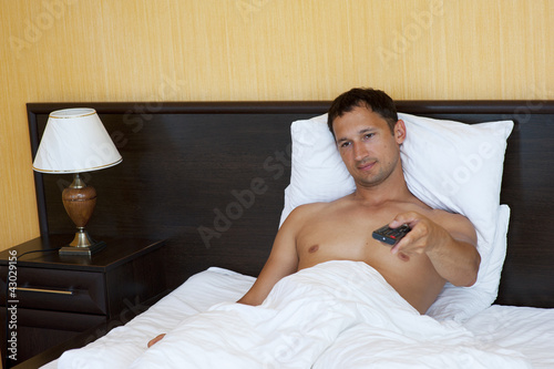 Photo: Handsome young man watching tv Handsome young man watching tv