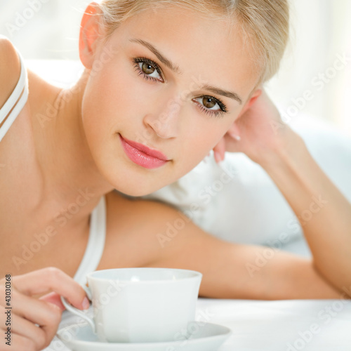Photo: Happy smiling woman at bedroom Happy smiling woman at bedroom