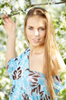 Spring woman in summer dress walking in park