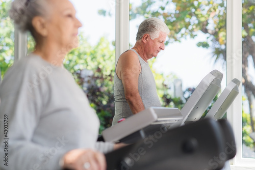 Photo: senior man exercising in wellness club senior man exercising in wellness club