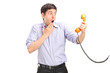 A shocked man holding a telephone tube