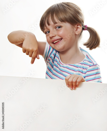 Photo: little girl pointing white blank with copy space little girl pointing white blank with copy space