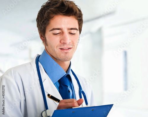 Photo: Doctor writing a prescription Doctor writing a prescription