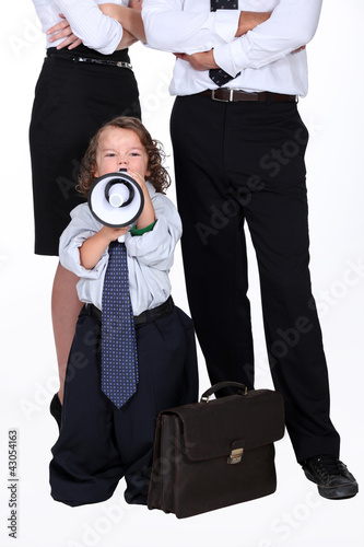 Photo: little boy protesting against business people little boy protesting against business people