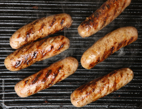 Foto: Sausages Cooking on Griddle Sausages Cooking on Griddle