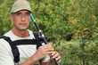 Freshwater fisherman casting his rod