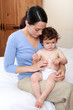 Mum applying cream to baby's rash