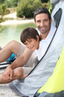 Father and son campink by a lake