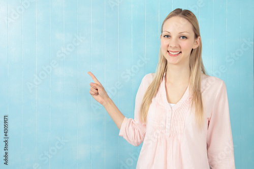 Photo: Beautiful young woman pointing Beautiful young woman pointing