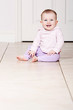 Baby Girl Sitting on Tiled Floor