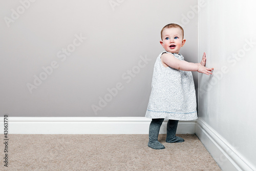 Photo: Shot of a Beautiful Baby Girl against Wall Shot of a Beautiful Baby Girl against Wall