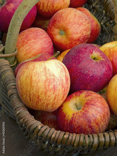 Photo: Fresh red apples in weaved basket. Fresh red apples in weaved basket.