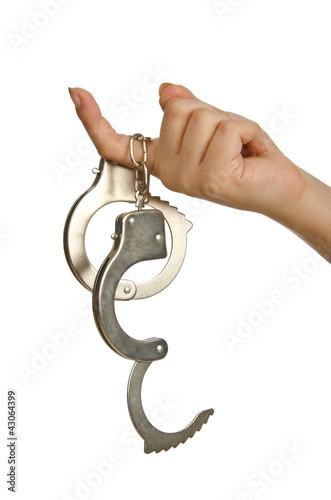 Photo: Handcuffed hands on white background Handcuffed hands on white background