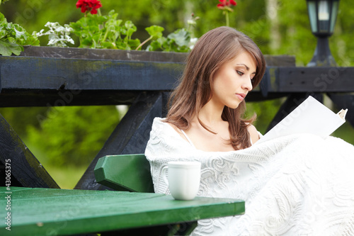 Photo: Young woman with cup outdoors Young woman with cup outdoors