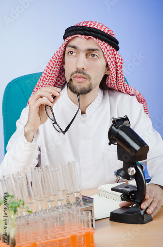 Photo: Arab chemist working in lab Arab chemist working in lab