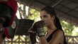 Woman exercising at boxing and self defense lesson in gym