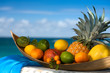 Foto: Tropical fruit basket , sea on the background Tropical fruit basket , sea on the background