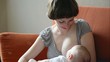 Young beautiful Mother breastfeeding her newborn baby