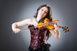 Female violin player against background